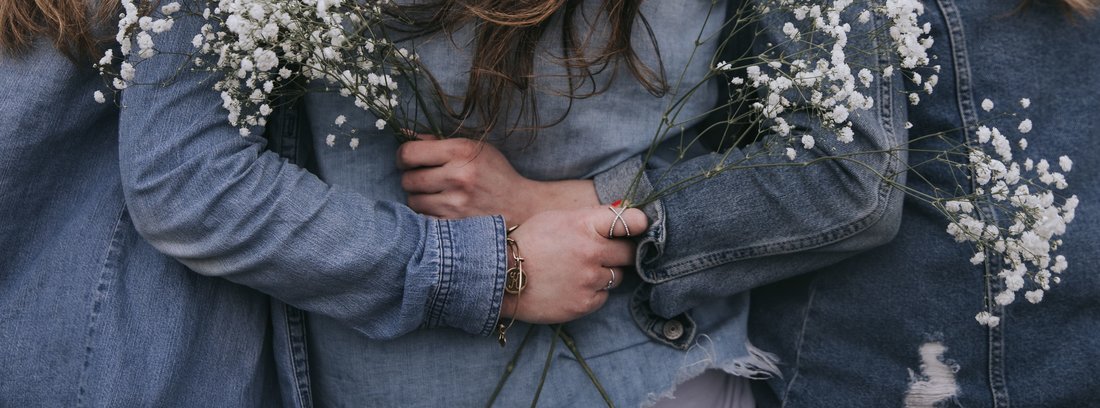 backs of women in jean jackets